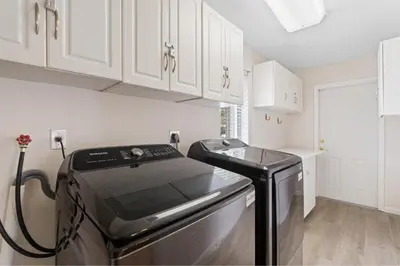 a kitchen with a stove and white cabinets at Boho Style 5 BR 2,5 BT Heated Pool Fit 14 in Miami