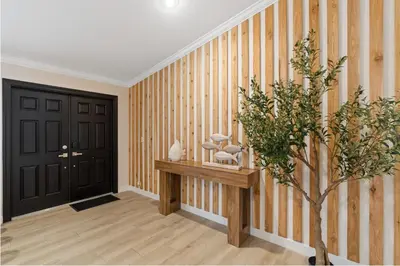 a hallway with striped walls and a black door at Boho Style 5 BR 2,5 BT Heated Pool Fit 14 in Miami