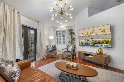 a living room with a couch and a table at Firepit, Beach, Basketball, LuxuryVilla in Palmetto Bay