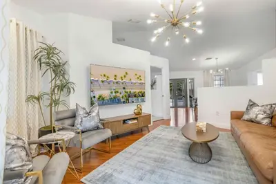 a living room with a couch and a table at Firepit, Beach, Basketball, LuxuryVilla in Palmetto Bay