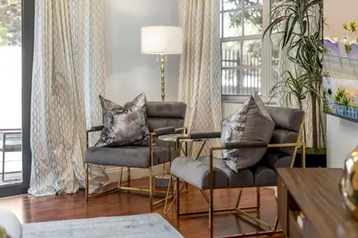 a living room with two chairs and a table at Firepit, Beach, Basketball, LuxuryVilla in Palmetto Bay