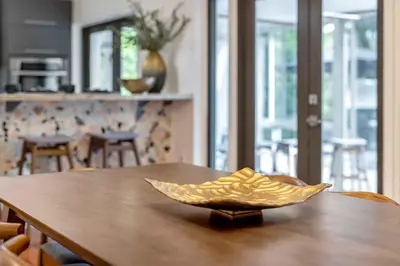 a gold bowl sitting on a wooden table at Firepit, Beach, Basketball, LuxuryVilla in Palmetto Bay