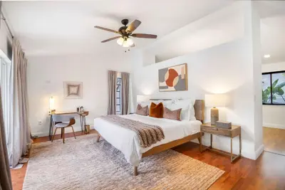 a bedroom with a bed and a ceiling fan at Firepit, Beach, Basketball, LuxuryVilla in Palmetto Bay