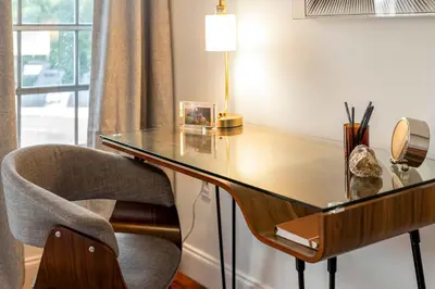 a desk with a chair and a table with a lamp at Firepit, Beach, Basketball, LuxuryVilla in Palmetto Bay