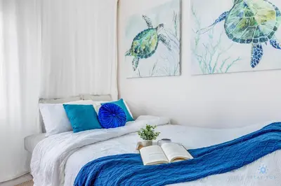 a bedroom with a bed with two books on it at Spacious Apt 2 Blocks to Beach and Collins Park in Miami Beach