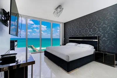 a bedroom with a bed and a view of the ocean at Pierfront Escape in Sunny Isles Beach