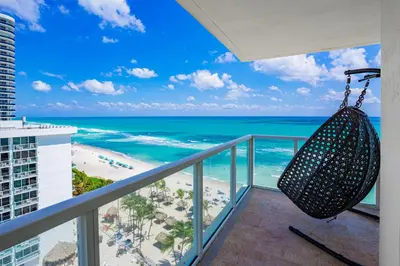 a balcony with a view of the beach and ocean at Pierfront Escape in Sunny Isles Beach