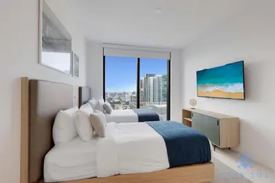 a bedroom with two beds and a large window at Condo Downtown in Miami