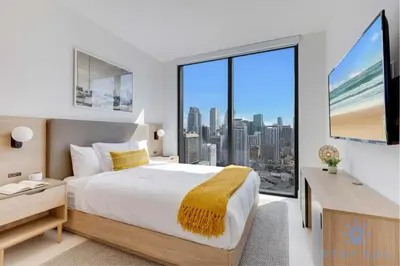 a bedroom with a large bed and a large window at Condo Downtown in Miami