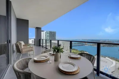 a dining room with a table and chairs on a balcony at Condo Downtown in Miami