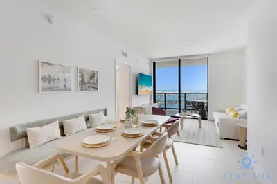 a dining room and living room with a table and chairs at Condo Downtown in Miami