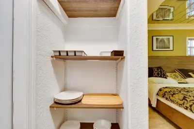 a room with a bed and a shelf with a toilet at Fort Lauderdale Studio Near Beaches and Downtown in Fort Lauderdale