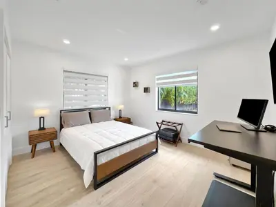 a bedroom with a bed and a desk and a computer at Brickell, Remote-Ready Oasis in Miami