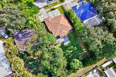 an overhead view of a house with a yard with trees at Brickell, Remote-Ready Oasis in Miami