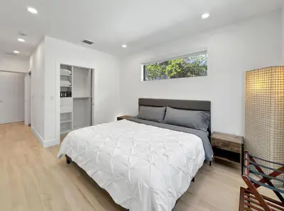 a bedroom with a large bed and a window at Brickell, Remote-Ready Oasis in Miami