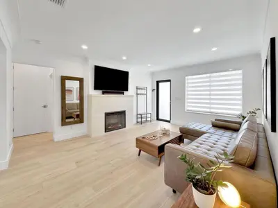 a living room with a couch and a fireplace at Brickell, Remote-Ready Oasis in Miami