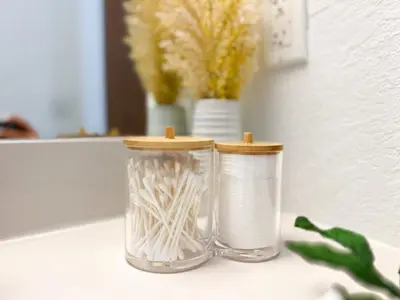 two glass jars sitting on a counter with flowers at Comfortable 2BR Apartment with Pool and Gym, Steps from Jackson Memorial in Miami