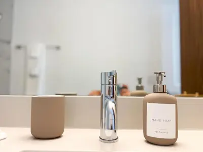 two bottles ofodorizers are sitting on a counter at Comfortable 2BR Apartment with Pool and Gym, Steps from Jackson Memorial in Miami