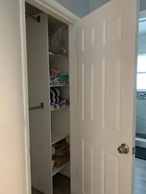 a closet with a white door and some towels at A place that will make you want to come back again in Miami Beach