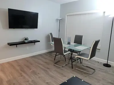 a conference room with a table and chairs and a flat screen tv at A place that will make you want to come back again in Miami Beach