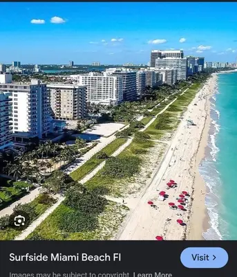 an aerial view of a beach with buildings and the ocean at A place that will make you want to come back again in Miami Beach