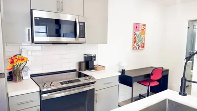 a kitchen with a stove and a microwave at The Chill Pill - Wilton Drive and Jacuzzi in Fort Lauderdale