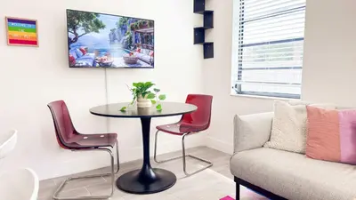a living room with a table and chairs and a couch at The Chill Pill - Wilton Drive and Jacuzzi in Fort Lauderdale