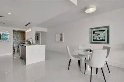 a kitchen and dining room with a table and chairs at Beachfront Bliss in Miami in Miami Beach