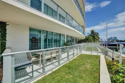a balcony of a building with chairs on it at Beachfront Bliss in Miami in Miami Beach