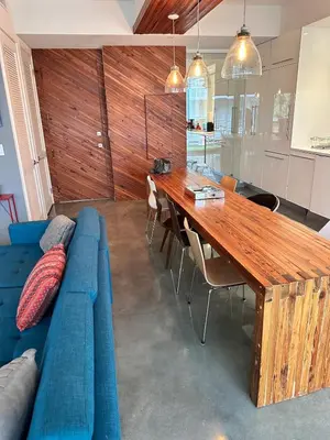 a living room with a blue couch and a wooden table at LoveShack Wynwood in Miami