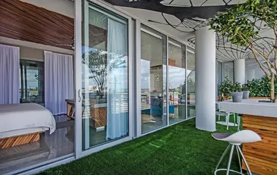a bedroom with a bed and a room with green grass at LoveShack Wynwood in Miami