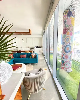 a living room with a blue couch and a large window at LoveShack Wynwood in Miami