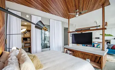 a bedroom with a large bed and a tv at LoveShack Wynwood in Miami