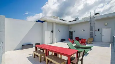 a patio with a red table and colorful chairs at LoveShack Wynwood in Miami