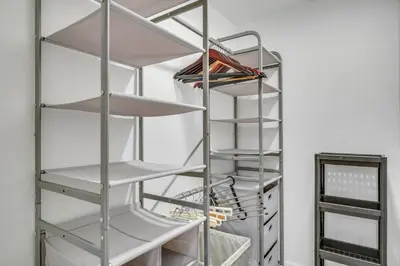 a room with white shelves in a closet at 3 Mi to Beach Hollywood Studio with Yard! in Hollywood
