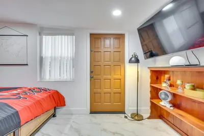 a bedroom with a bed and a yellow door at 3 Mi to Beach Hollywood Studio with Yard! in Hollywood