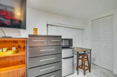 a small kitchen with a table and a microwave at 3 Mi to Beach Hollywood Studio with Yard! in Hollywood
