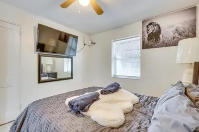 a bedroom with a bed and a flat screen tv at 3 Mi to Beach Hollywood Treehouse with Deck and Yard! in Hollywood
