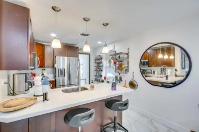a kitchen with a sink and a mirror at 3 Mi to Beach Hollywood Treehouse with Deck and Yard! in Hollywood