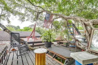 a tree house with a ladder in a tree at 3 Mi to Beach Hollywood Treehouse with Deck and Yard! in Hollywood