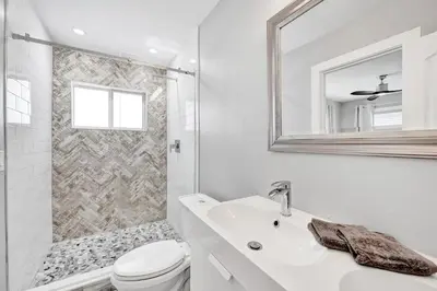 a white bathroom with a toilet and a sink at NEW! Private Oasis with Heated Pool Minutes to Wilton Dr and the Beach in Fort Lauderdale