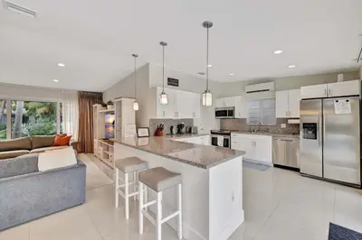 a kitchen and living room with a counter and a couch at Waterfront Oasis with Private Pool in Fort Lauderdale