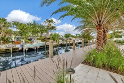 a resort with a pool and palm trees at Waterfront Oasis with Private Pool in Fort Lauderdale