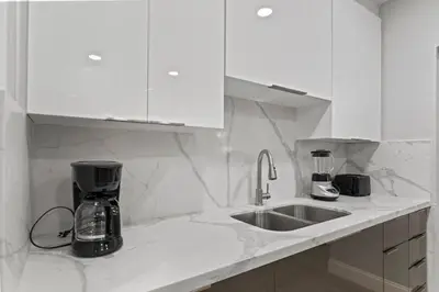 a kitchen with a sink and a coffee maker on a counter at Family Oasis Near Hard Rock Stadium & Beaches in Norland