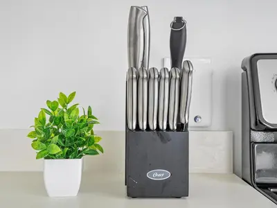 a knife block sitting on a counter next to a plant at X Lounge VI-Premium Corner Residence in Miami