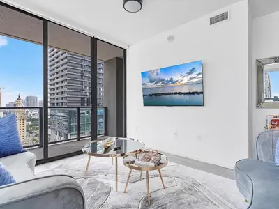 a living room with a table and a large window at X Lounge VI-Premium Corner Residence in Miami