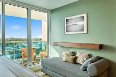 a living room with a couch and a balcony at Skyline Studio at Roney Palace - 1429 in Miami Beach