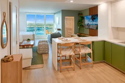 a kitchen and living room with a table and chairs at Skyline Studio at Roney Palace - 1429 in Miami Beach