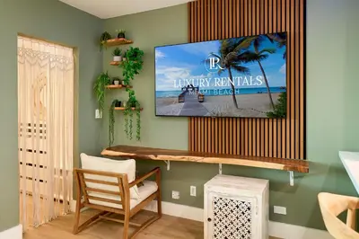 a living room with a tv on a wall at Skyline Studio at Roney Palace - 1429 in Miami Beach