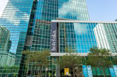 a tall glass building with a sign on it at ★Luxury Studio with king bed+Free Parking+Netflix★ in Miami